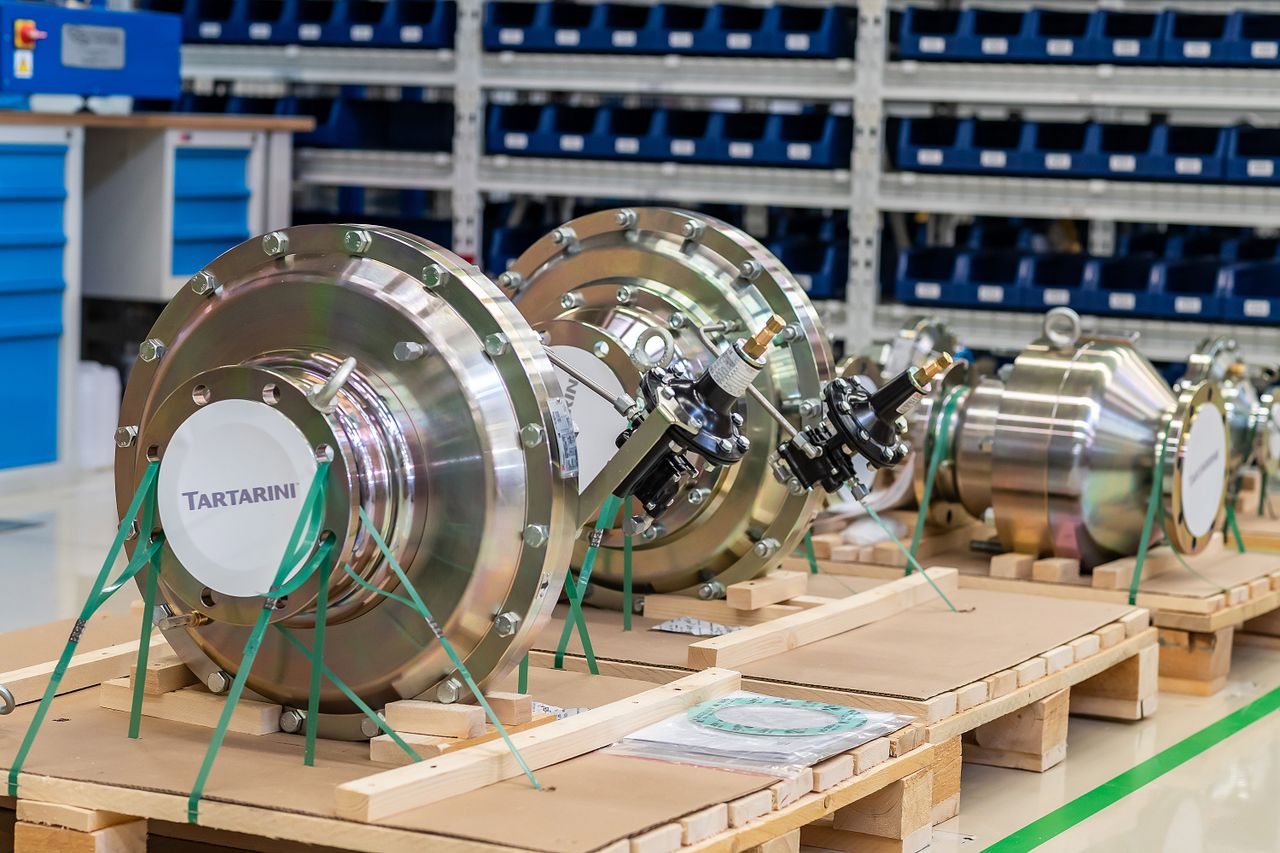 Services Large industrial valves stored in an organized workshop environment.